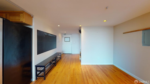 interior space with electric panel and light hardwood / wood-style flooring