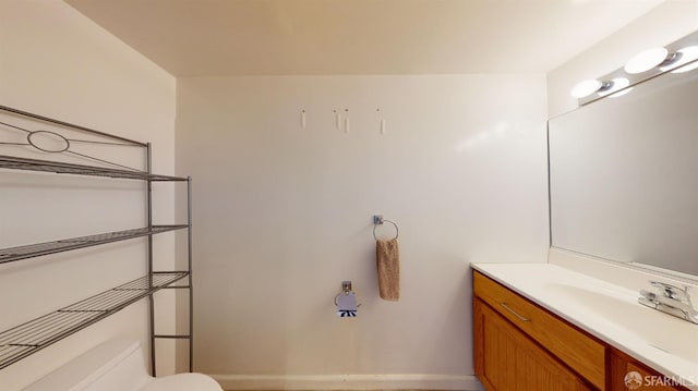 bathroom featuring vanity and toilet