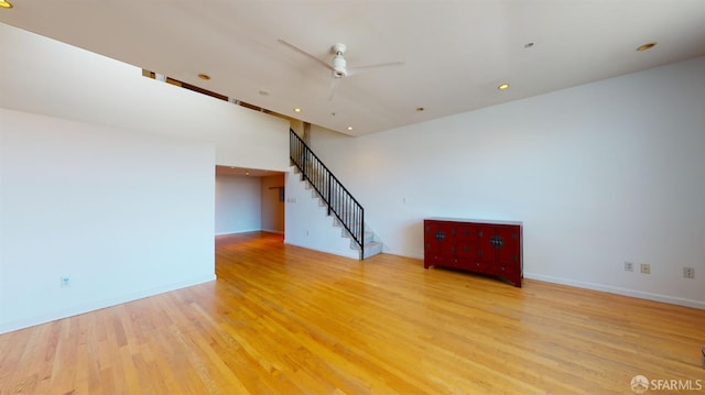 empty room with light wood-type flooring and ceiling fan