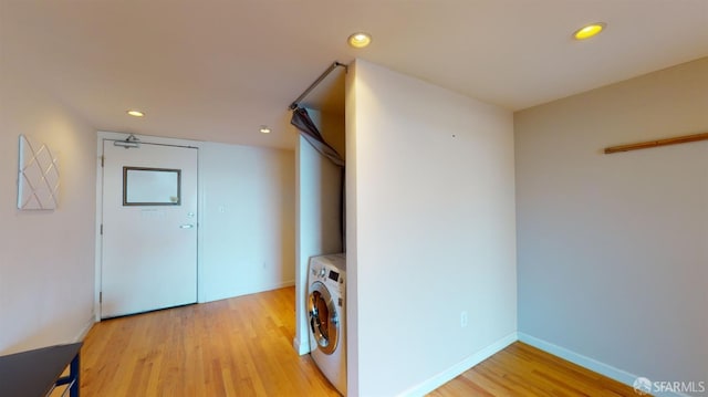 interior space featuring light wood-type flooring and washing machine and clothes dryer