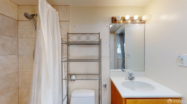 bathroom featuring vanity, toilet, and a shower with curtain