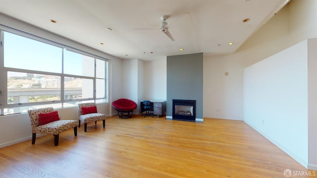 living area featuring ceiling fan and light wood-type flooring