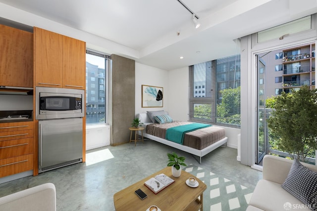 766 Harrison St Unit 403, San Francisco, CA 94107 - bedroom with track lighting, finished concrete floors, and refrigerator
