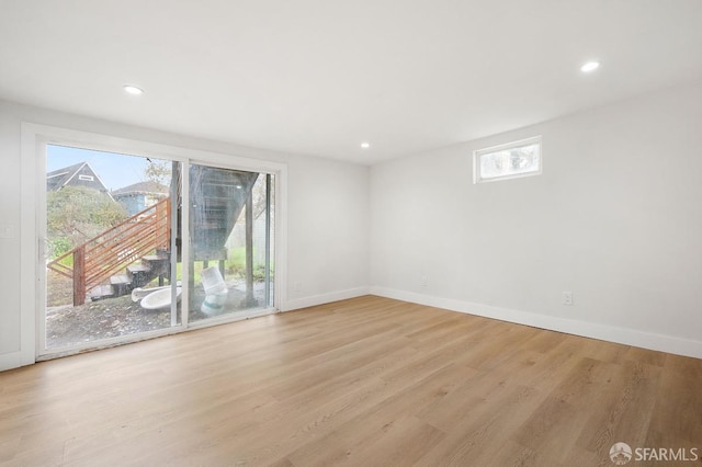 spare room featuring a healthy amount of sunlight and light wood-type flooring