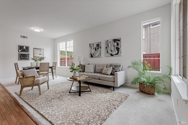 living room featuring baseboards and visible vents