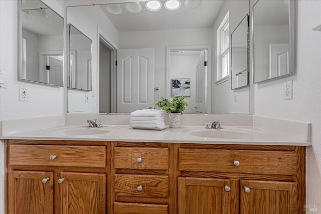 full bathroom with double vanity and a sink