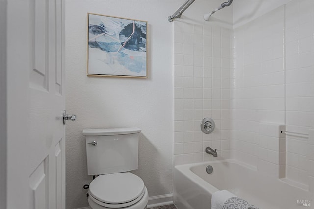 full bath with washtub / shower combination, baseboards, and toilet