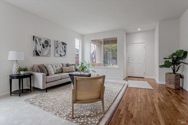 living area with recessed lighting, wood finished floors, and baseboards