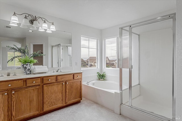 bathroom featuring double vanity, a shower stall, visible vents, and a sink