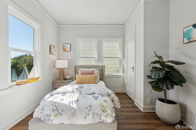 bedroom featuring baseboards, dark wood-type flooring, and crown molding