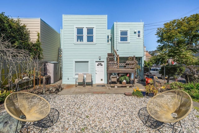 back of property with a patio area and fence