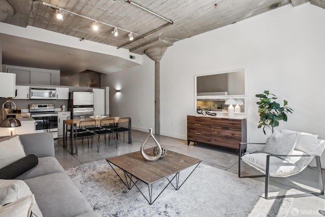 300 Beale St Unit 504, San Francisco, CA 94105 - living room with concrete flooring, baseboards, and rail lighting
