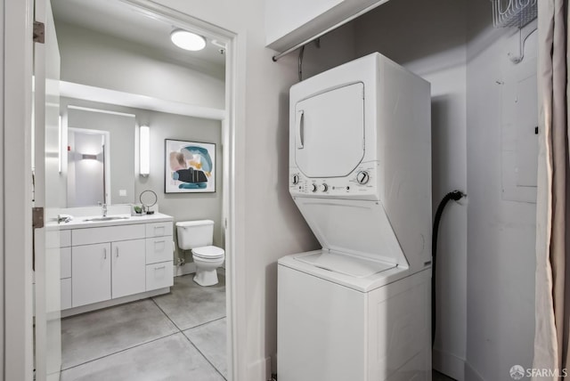 300 Beale St Unit 504, San Francisco, CA 94105 - washroom featuring estacked washer and dryer and light tile patterned floors