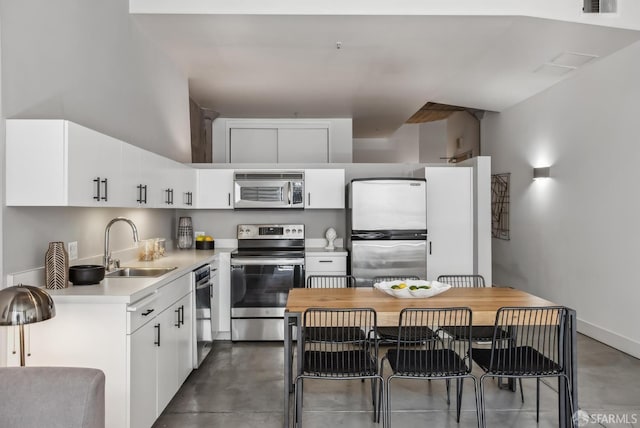 300 Beale St Unit 504, San Francisco, CA 94105 - kitchen with stainless steel appliances, a sink, concrete floors, and white cabinets