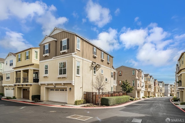 view of property with a garage and a residential view