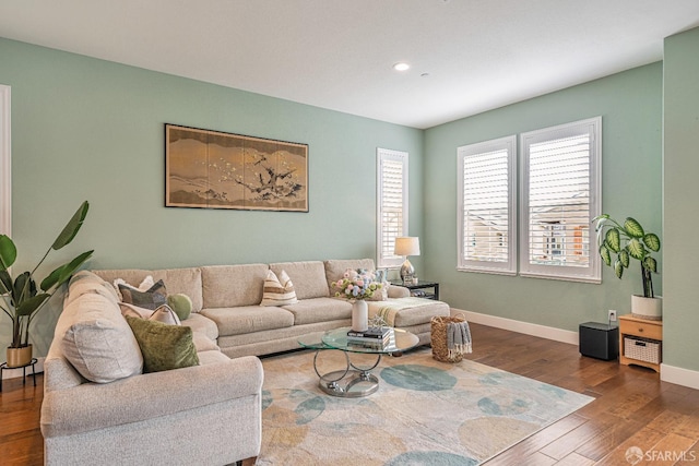 living room featuring recessed lighting, baseboards, and wood finished floors