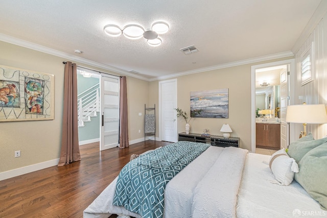 bedroom featuring crown molding, a textured ceiling, visible vents, and wood finished floors