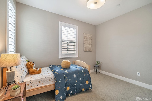 carpeted bedroom with baseboards