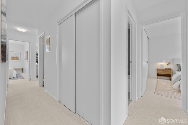 corridor featuring light carpet