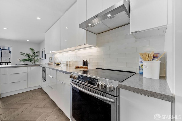 kitchen featuring stainless steel electric range oven, extractor fan, modern cabinets, white cabinets, and recessed lighting
