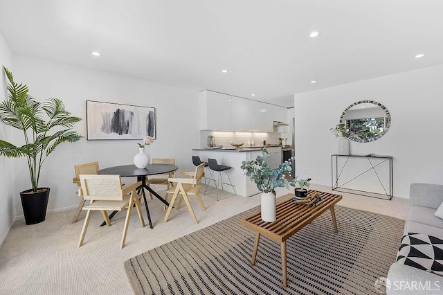 living room with light colored carpet and recessed lighting