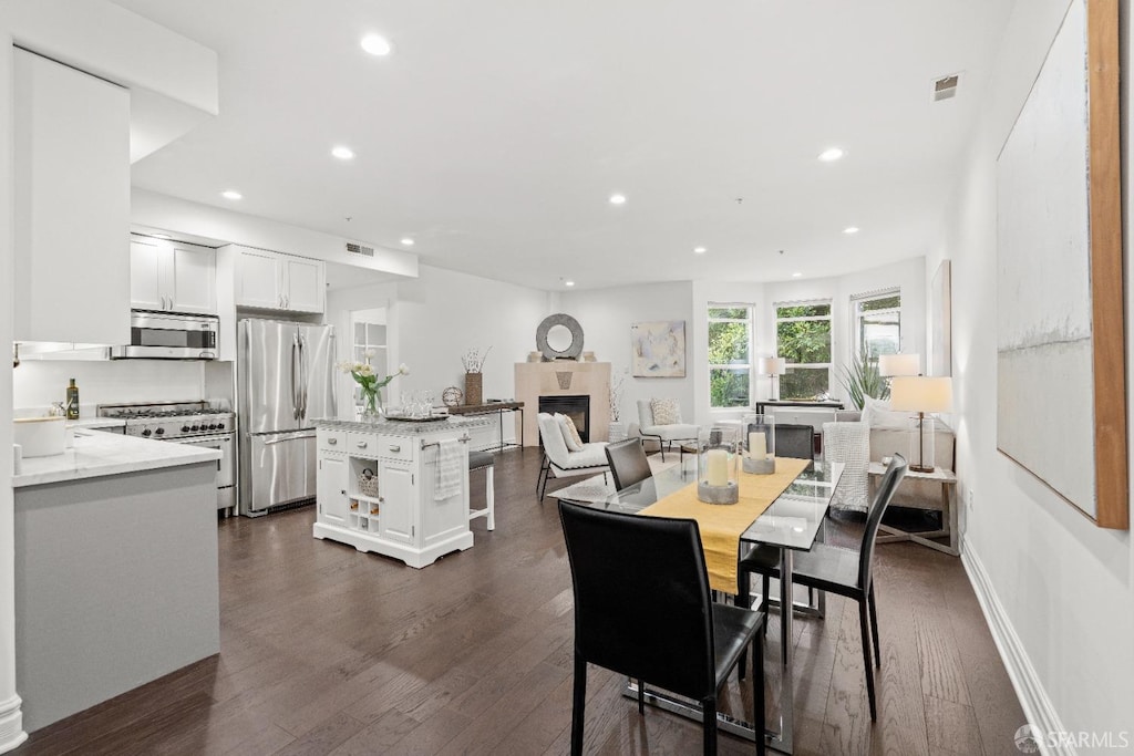 dining space with dark hardwood / wood-style flooring