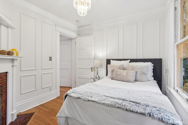 bedroom with light hardwood / wood-style floors and a chandelier