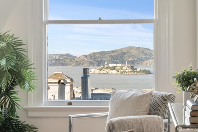 interior space with a wealth of natural light and a water and mountain view