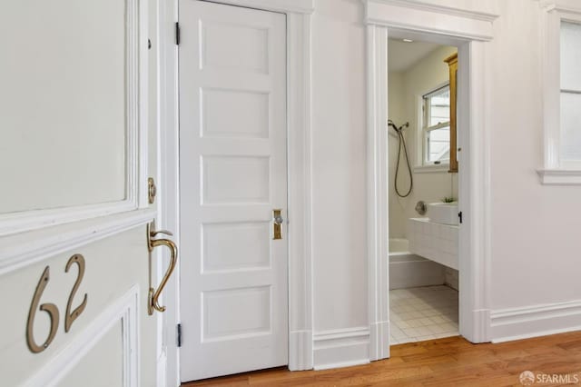 bathroom featuring wood-type flooring and shower / bath combination