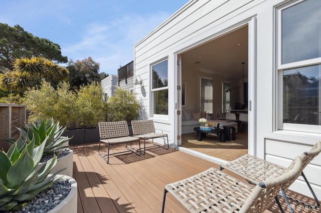wooden terrace featuring fence