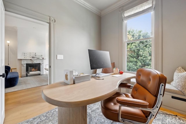 office area with crown molding, a high end fireplace, and wood finished floors