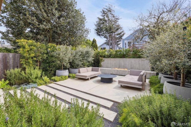 view of patio with an outdoor living space with a fire pit and fence private yard