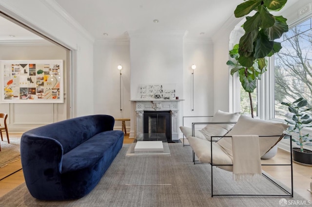 living room featuring a high end fireplace and crown molding