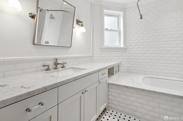 full bath featuring vanity, tile patterned floors, a tile shower, and tile walls