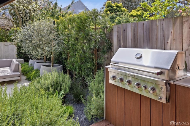 view of patio / terrace with grilling area and fence