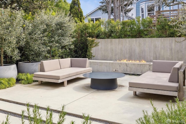 view of patio featuring outdoor lounge area and fence