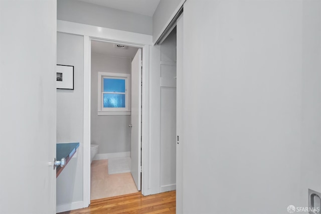 2195 Green St Unit 2, San Francisco, CA 94123 - bathroom featuring toilet, baseboards, and wood finished floors
