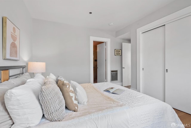 2195 Green St Unit 2, San Francisco, CA 94123 - bedroom with heating unit, a closet, and wood finished floors