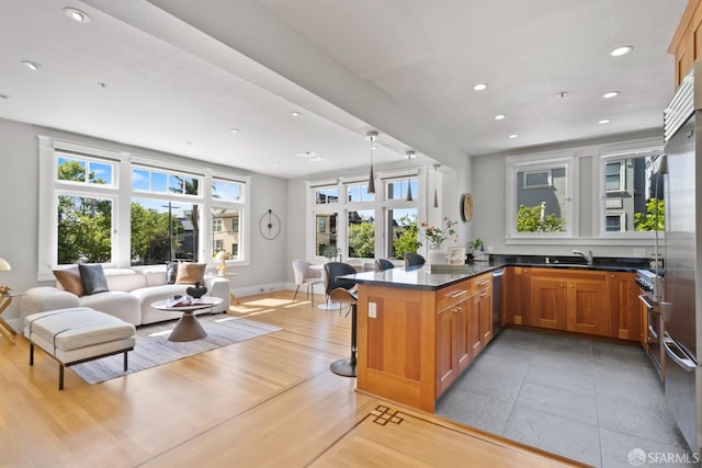 2195 Green St Unit 2, San Francisco, CA 94123 - kitchen featuring brown cabinetry, recessed lighting, open floor plan, baseboards, and a peninsula