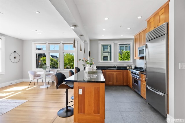 2195 Green St Unit 2, San Francisco, CA 94123 - kitchen with built in appliances, dark countertops, a kitchen breakfast bar, recessed lighting, and a sink
