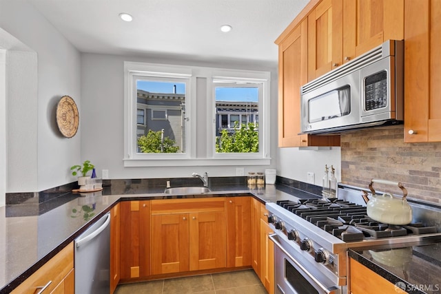 2195 Green St Unit 2, San Francisco, CA 94123 - kitchen with a sink, dark stone countertops, stainless steel appliances, recessed lighting, and decorative backsplash