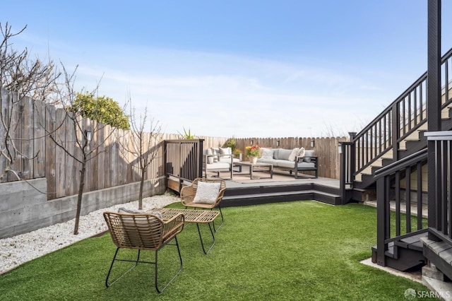 view of yard featuring outdoor lounge area, stairway, a deck, and a fenced backyard