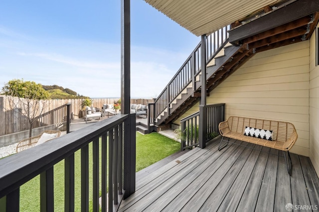 deck featuring stairway, a fenced backyard, and a lawn