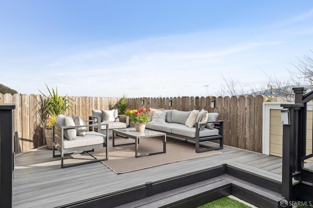 wooden deck featuring an outdoor hangout area and fence