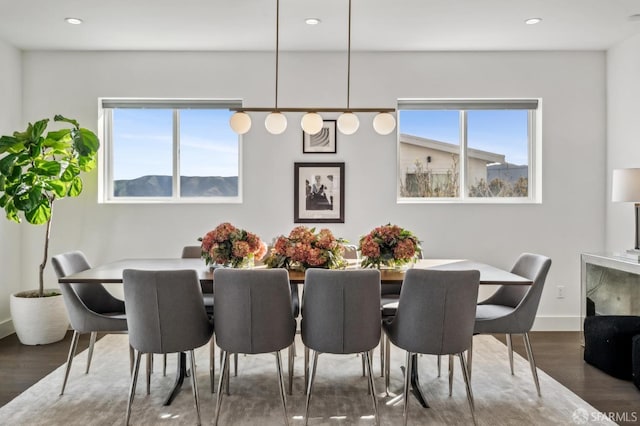 dining space featuring plenty of natural light, recessed lighting, baseboards, and wood finished floors