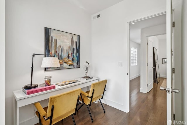 home office with visible vents, baseboards, and wood finished floors