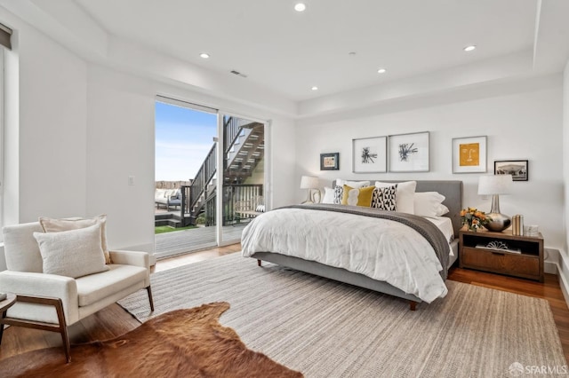 bedroom featuring access to outside, recessed lighting, wood finished floors, and visible vents