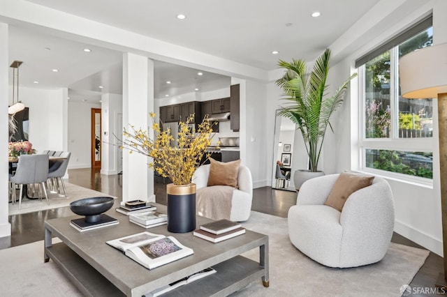 living room featuring recessed lighting, baseboards, and light wood finished floors