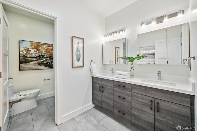 full bath featuring tile patterned floors, toilet, baseboards, and a sink