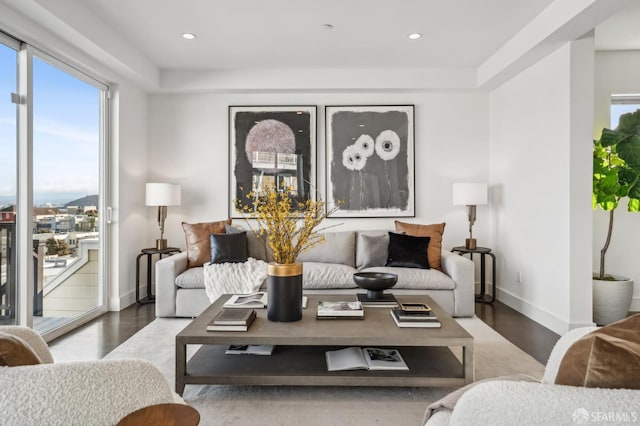 living room featuring recessed lighting, wood finished floors, and baseboards